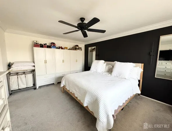 a bedroom with a bed and a ceiling fan