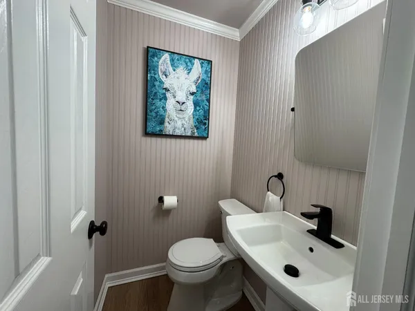 a bathroom with a sink and mirror with toilet