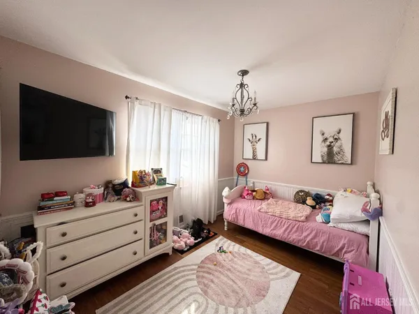 a bedroom with a bed and flat screen tv