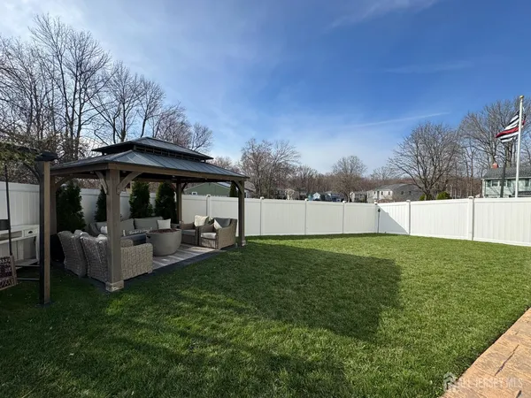a view of backyard with green space and porch