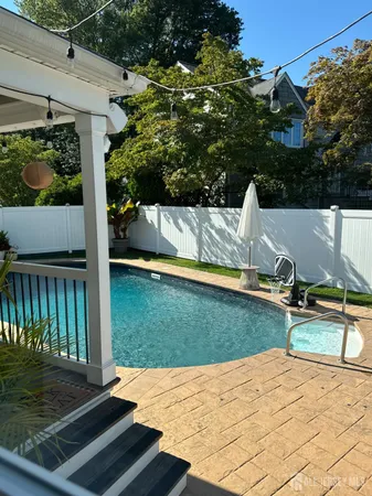 a view of a backyard with sitting area