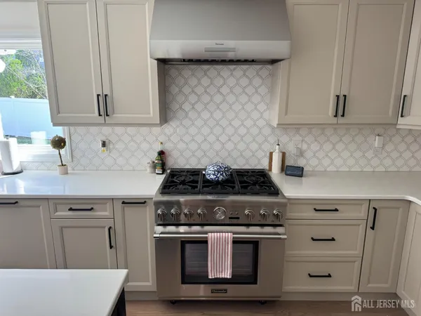 a stove top oven sitting inside of a kitchen