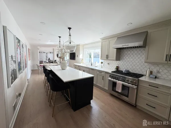 a kitchen with stainless steel appliances a table chairs and a refrigerator