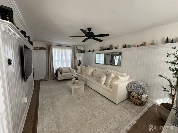 a living room with furniture and a chandelier
