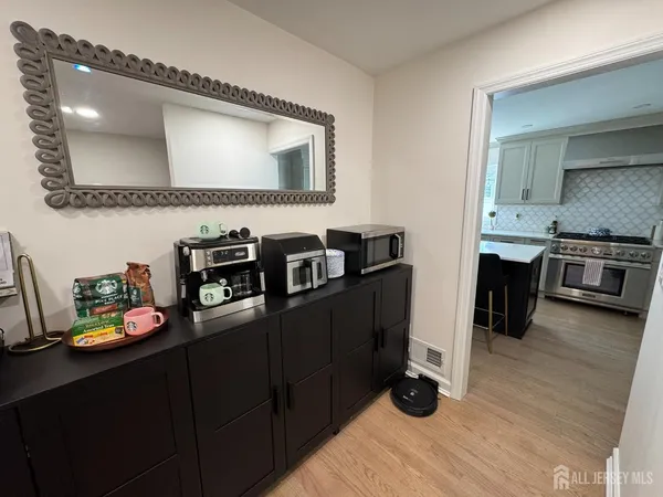 a kitchen with cabinets and wooden floor