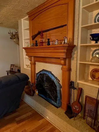 a view of a livingroom with a fireplace and a window