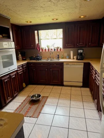 a kitchen with a sink a stove a microwave and cabinets