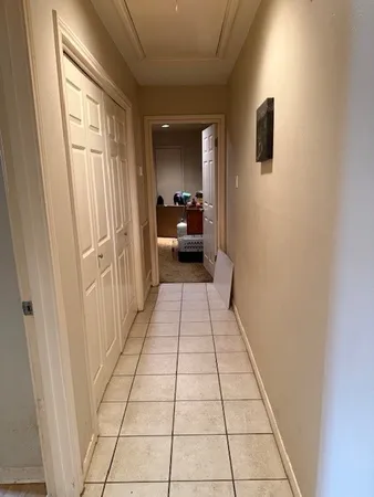 a hallway with a black white checkered floor