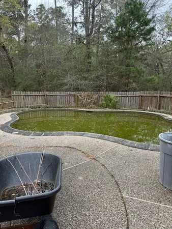 a view of a swimming pool with a yard