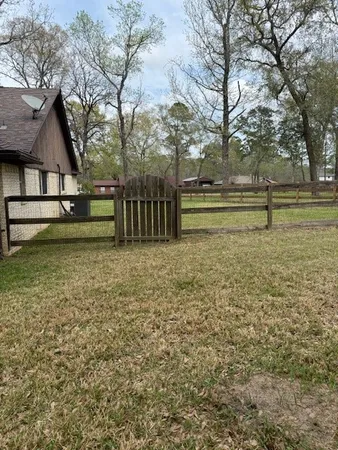 a view of a yard with large trees