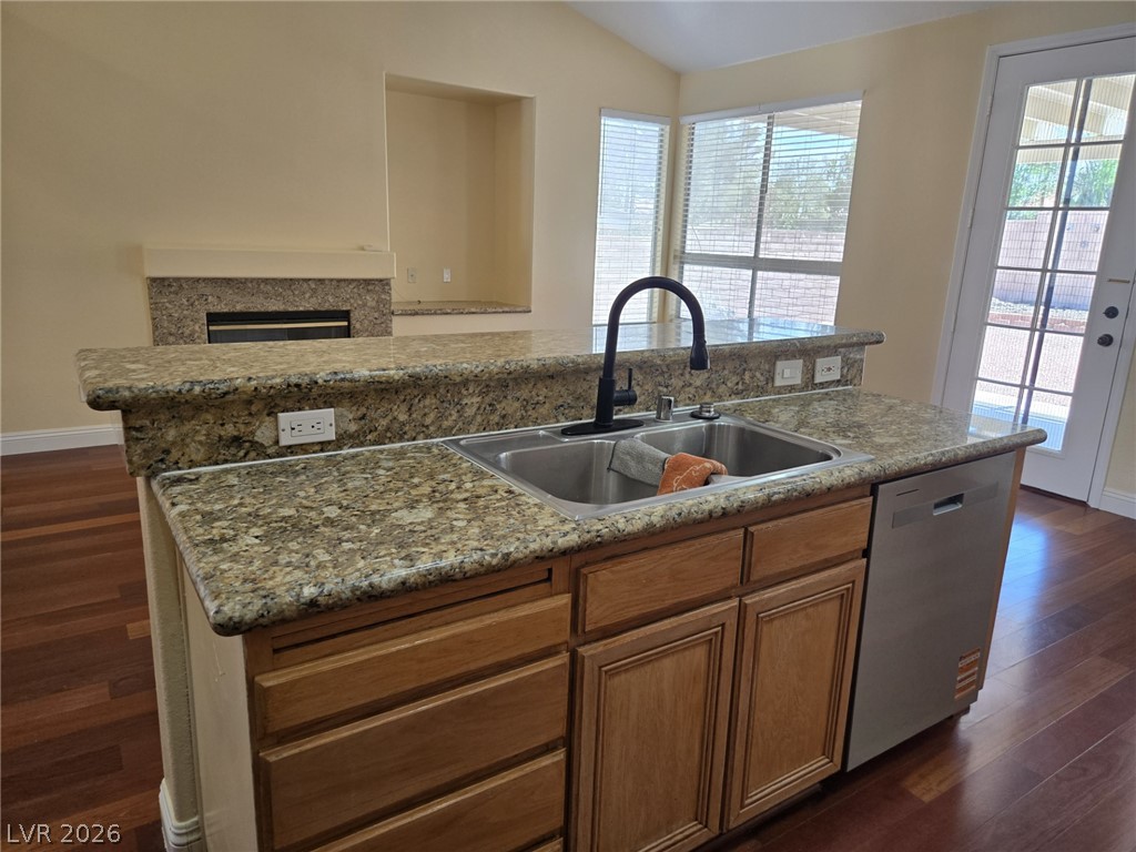 8417 San Ramon Drive Las Vegas, NV 89147 - Photo 16 of 33 A functional kitchen island features a double sink, dishwasher, and ample counter space for culinary tasks.