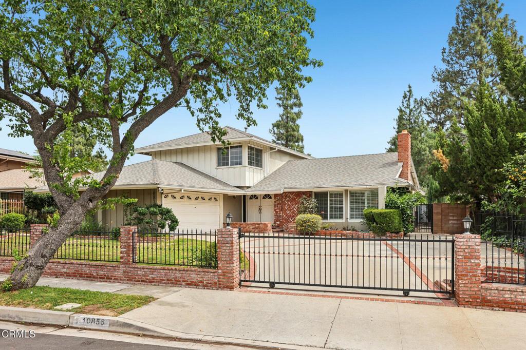 10856 Topeka Drive Porter Ranch, CA 91326 - Photo 2 of 40 a front view of a house with a garden