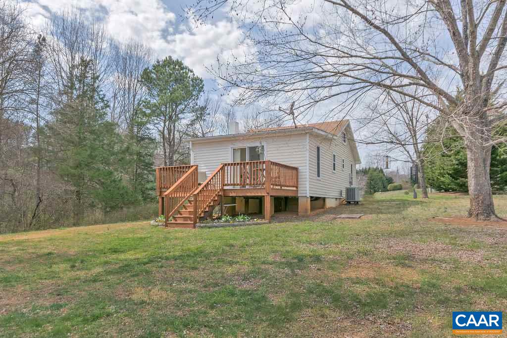 782 West Daffodil Road Ruckersville, VA 22968 - Photo 16 of 18 a view of a house with a big yard and large trees
