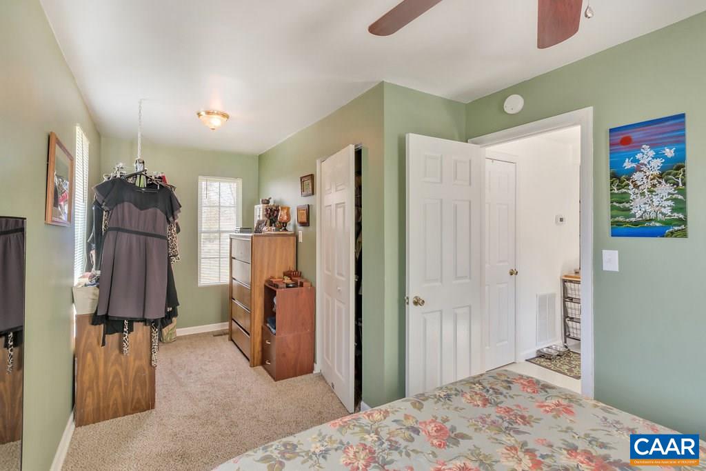 782 West Daffodil Road Ruckersville, VA 22968 - Photo 10 of 18 a bedroom with a bed and a large mirror