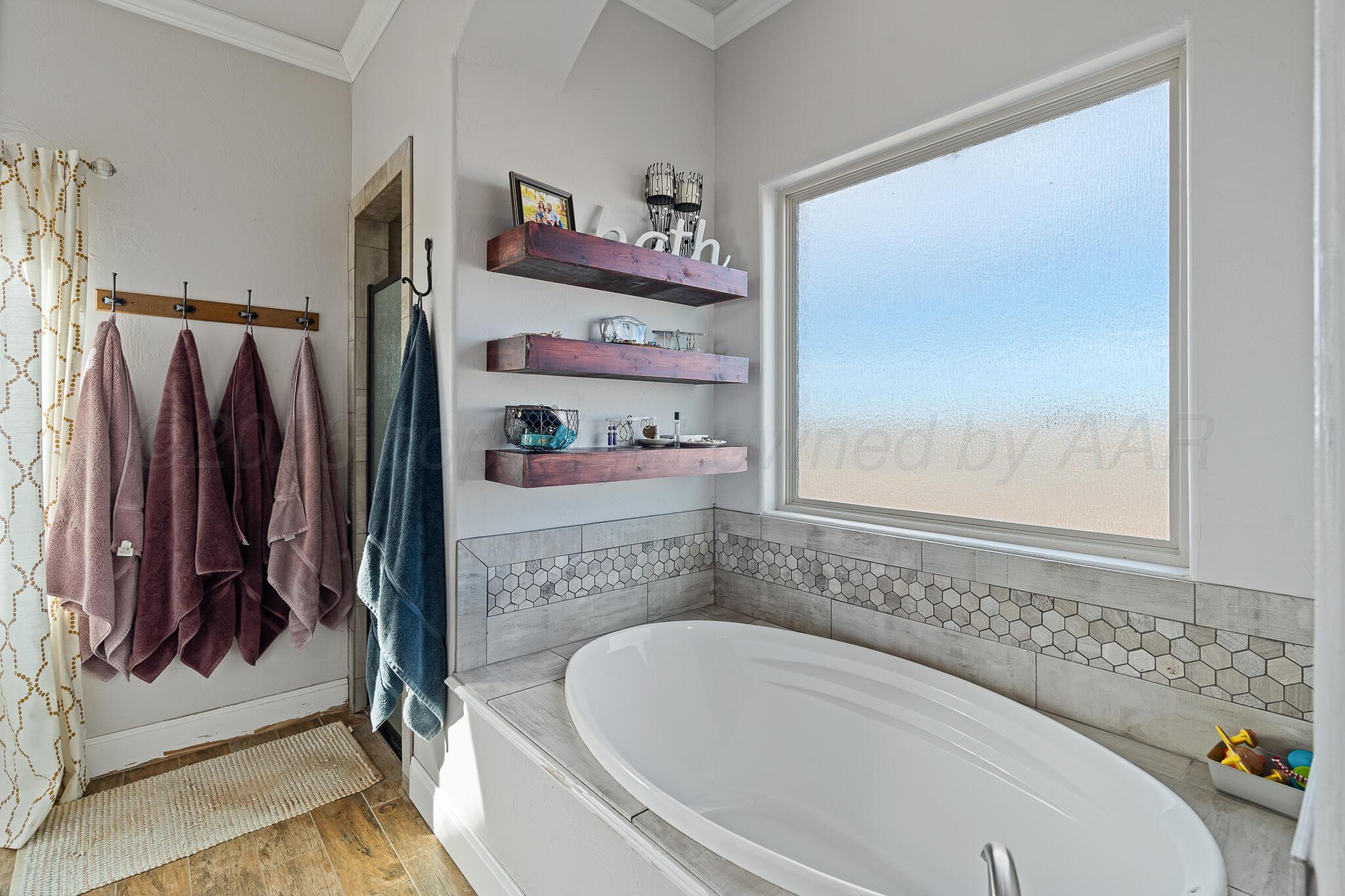 19000 Spirit Loop Amarillo, TX 79119 - Photo 22 of 86 a bathroom with a bathtub and a window
