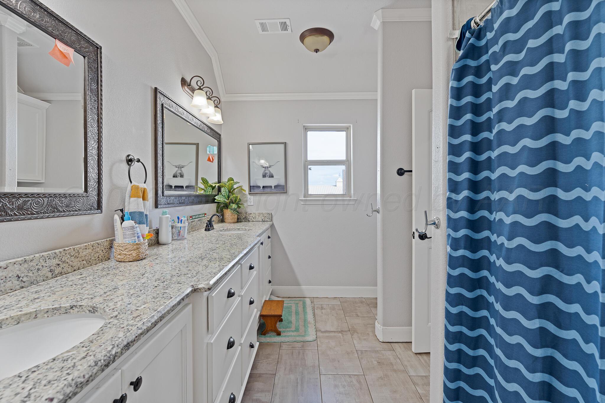 19000 Spirit Loop Amarillo, TX 79119 - Photo 29 of 86 a bathroom with a granite countertop sink and a mirror