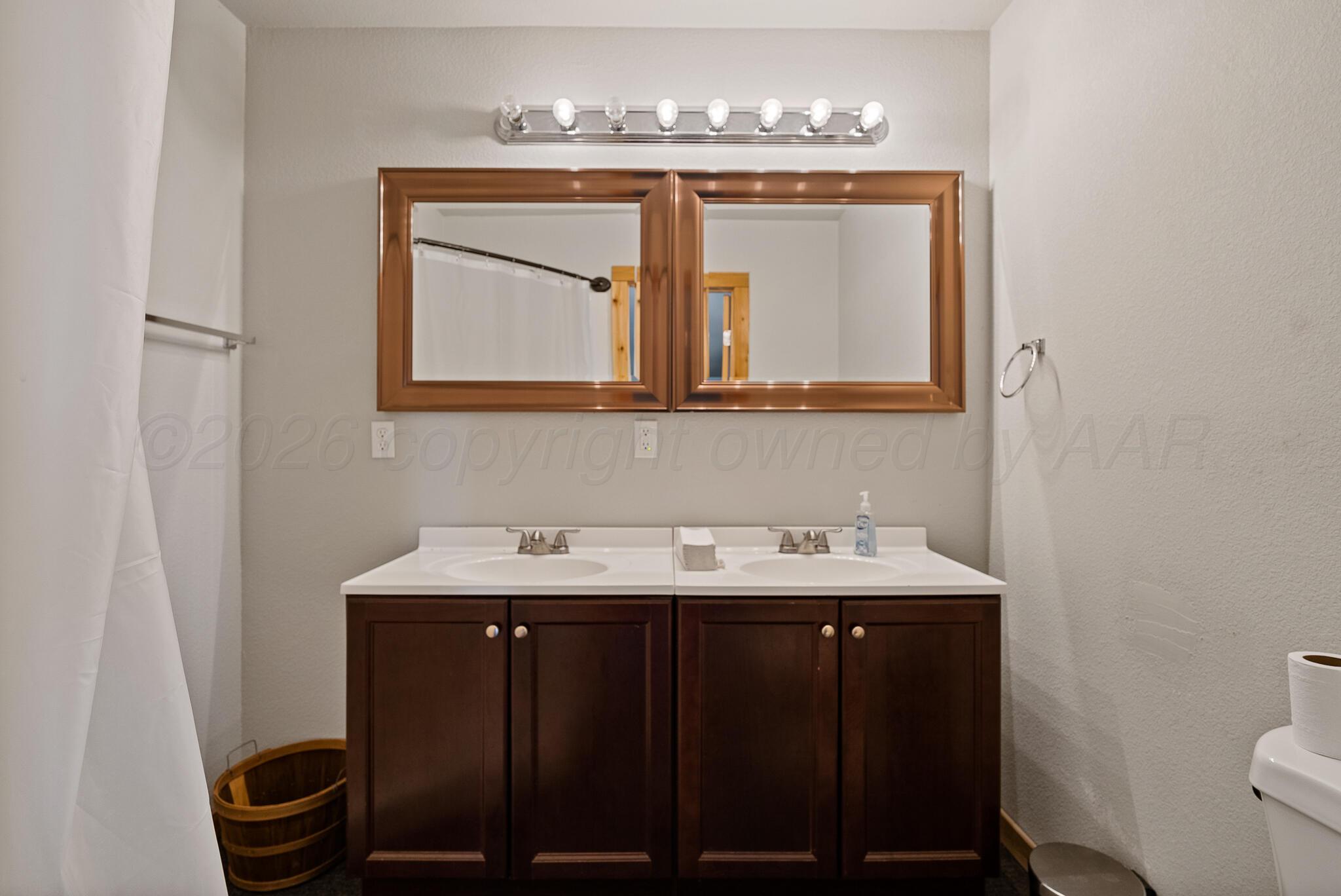 19000 Spirit Loop Amarillo, TX 79119 - Photo 49 of 86 a bathroom with a sink and a mirror