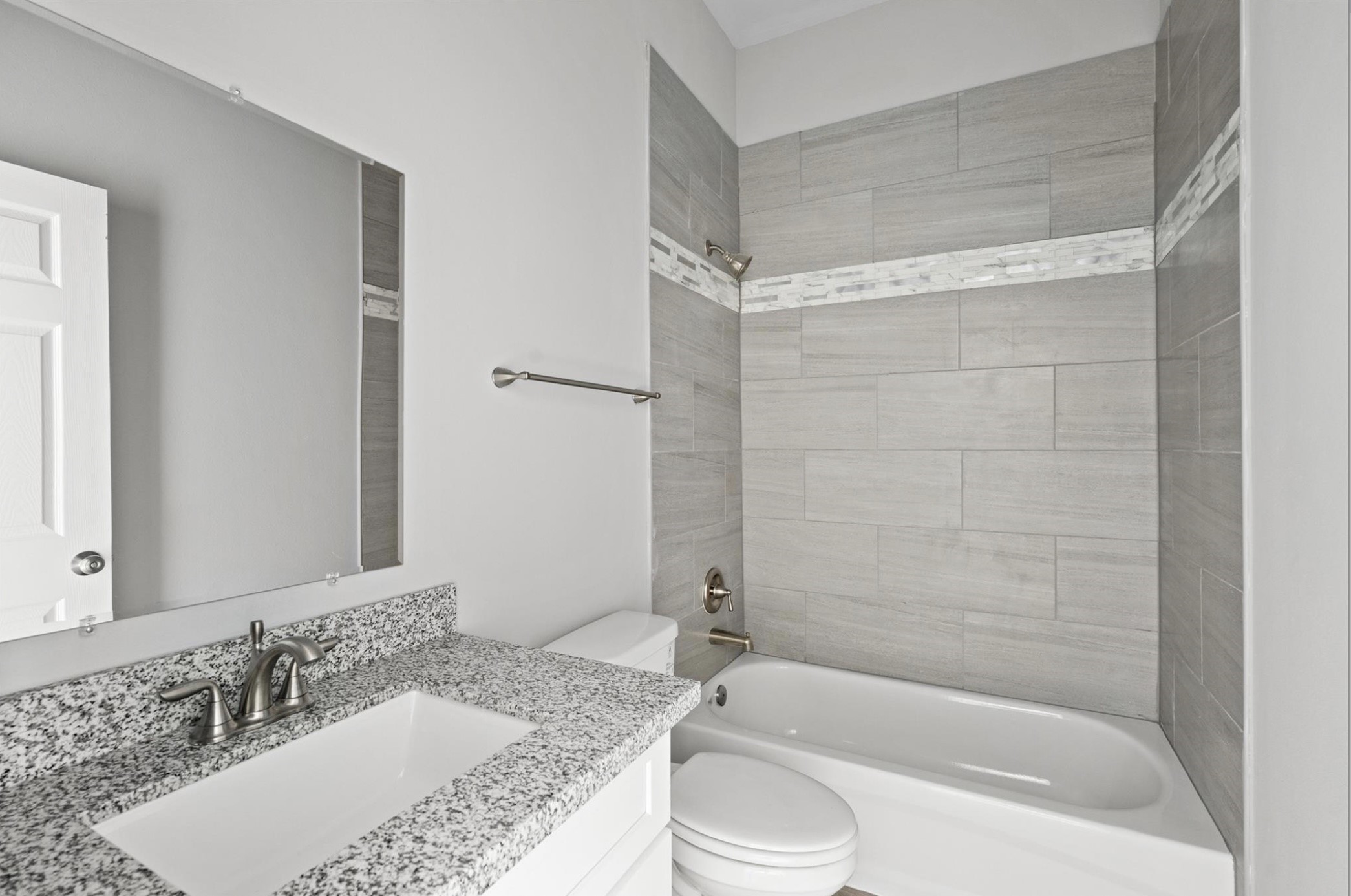 8204 Tower Street Houston, TX 77088 - Photo 11 of 24 a bathroom with a granite countertop tub sink and mirror