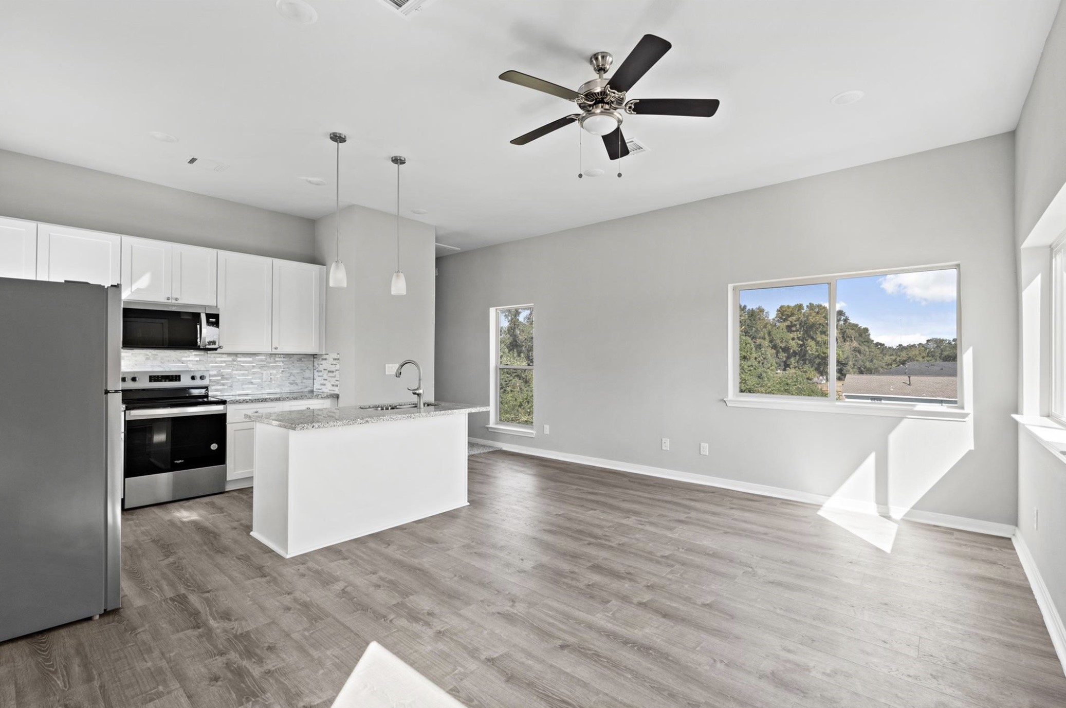 8204 Tower Street Houston, TX 77088 - Photo 19 of 24 a large kitchen with cabinets wooden floor and stainless steel appliances