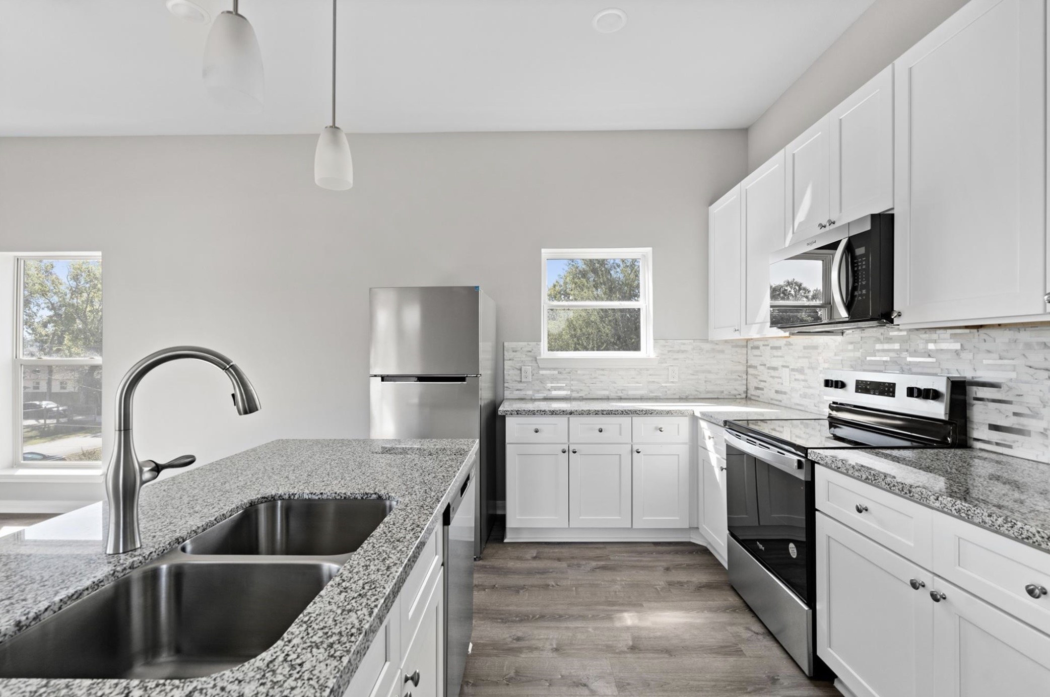 8204 Tower Street Houston, TX 77088 - Photo 20 of 24 a kitchen with sink a stove and cabinets