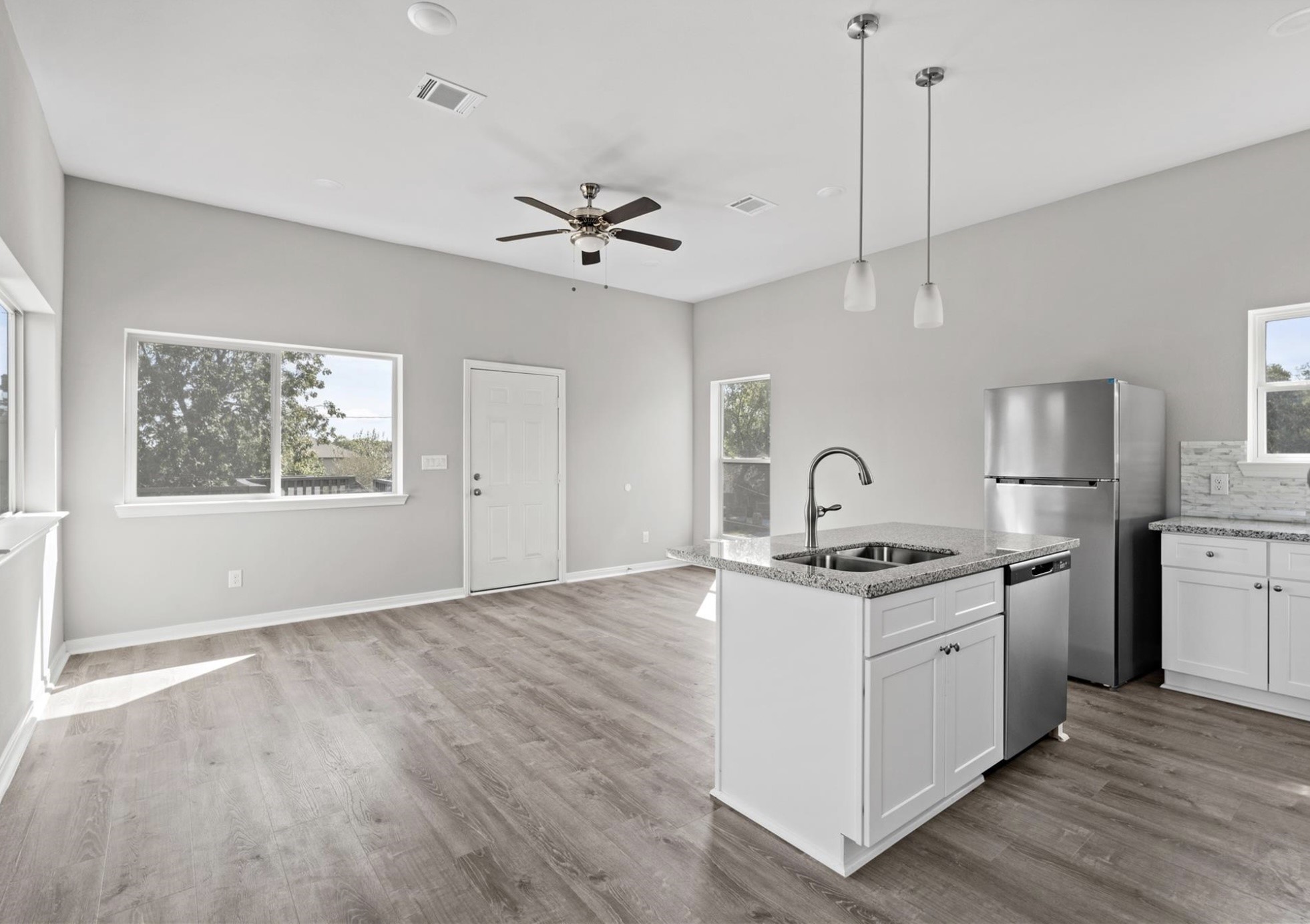 8204 Tower Street Houston, TX 77088 - Photo 2 of 24 a kitchen with stainless steel appliances granite countertop a stove a sink dishwasher a refrigerator and white cabinets with wooden floor