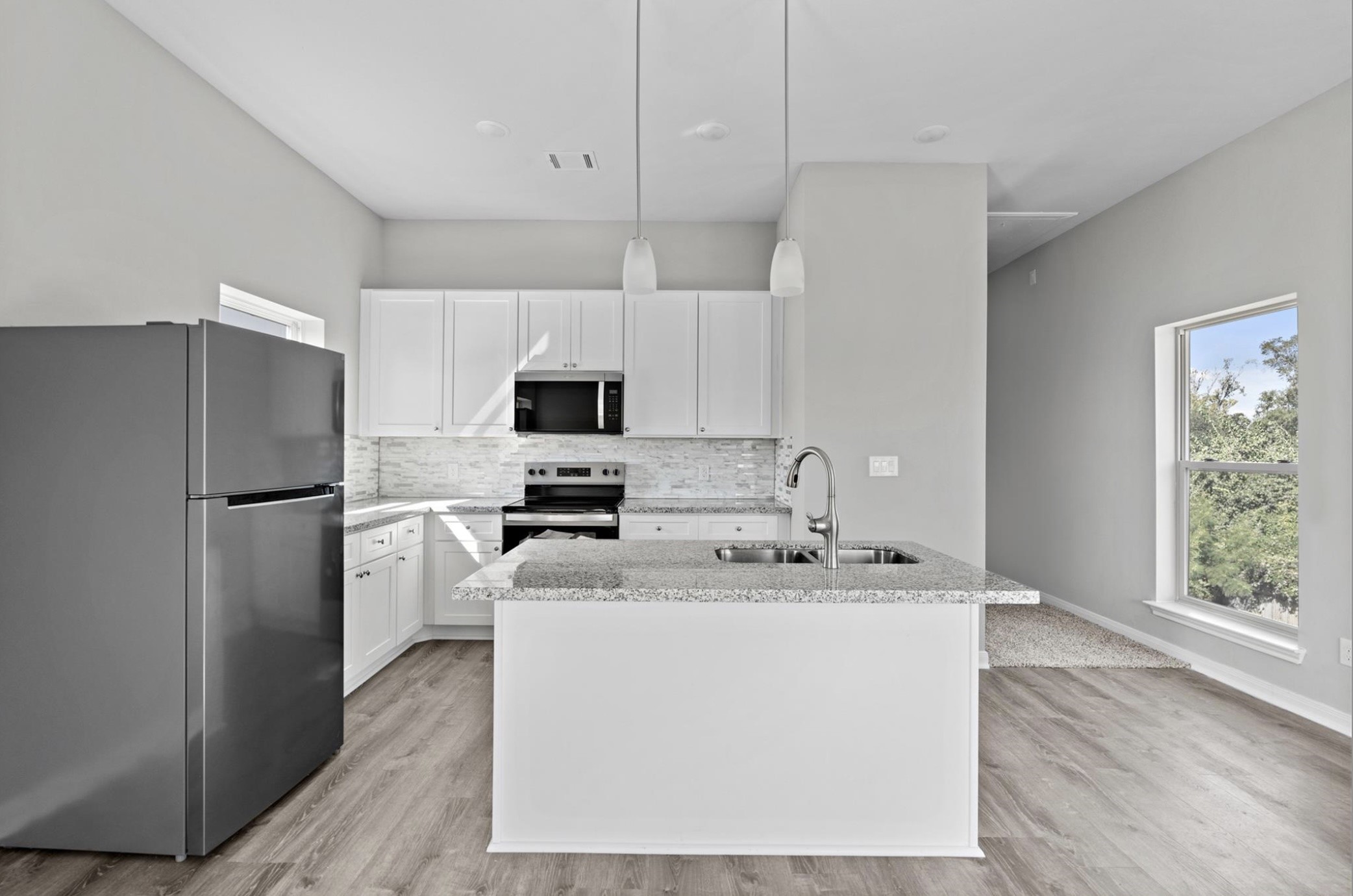 8204 Tower Street Houston, TX 77088 - Photo 21 of 24 a kitchen with stainless steel appliances a refrigerator a sink a stove a microwave and island