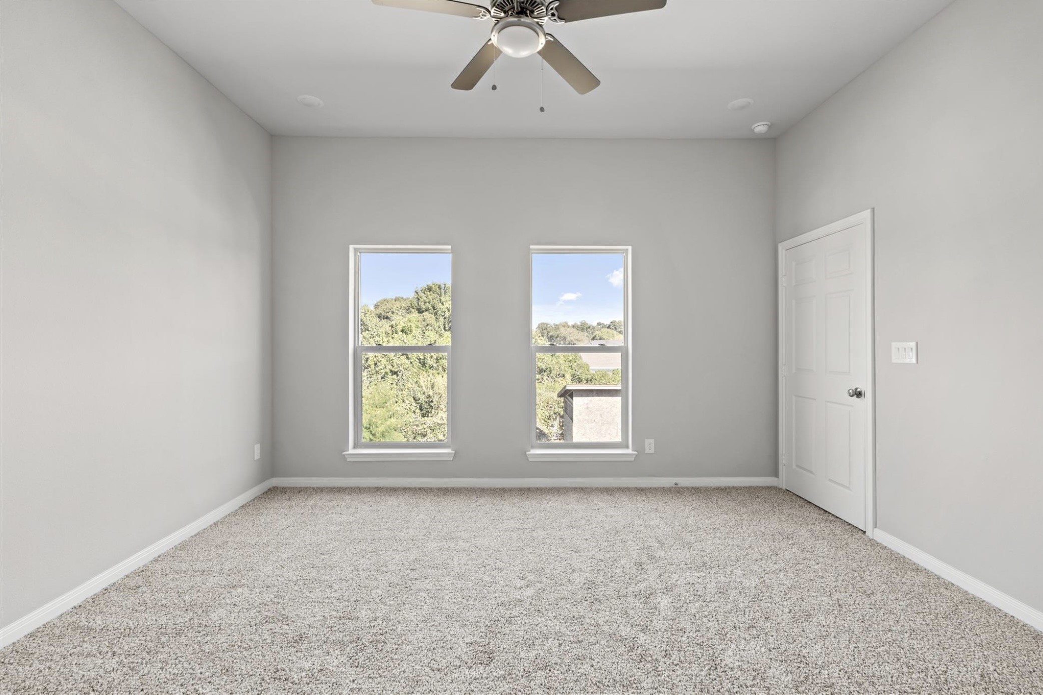 8204 Tower Street Houston, TX 77088 - Photo 8 of 24 an empty room with windows and chandelier fan