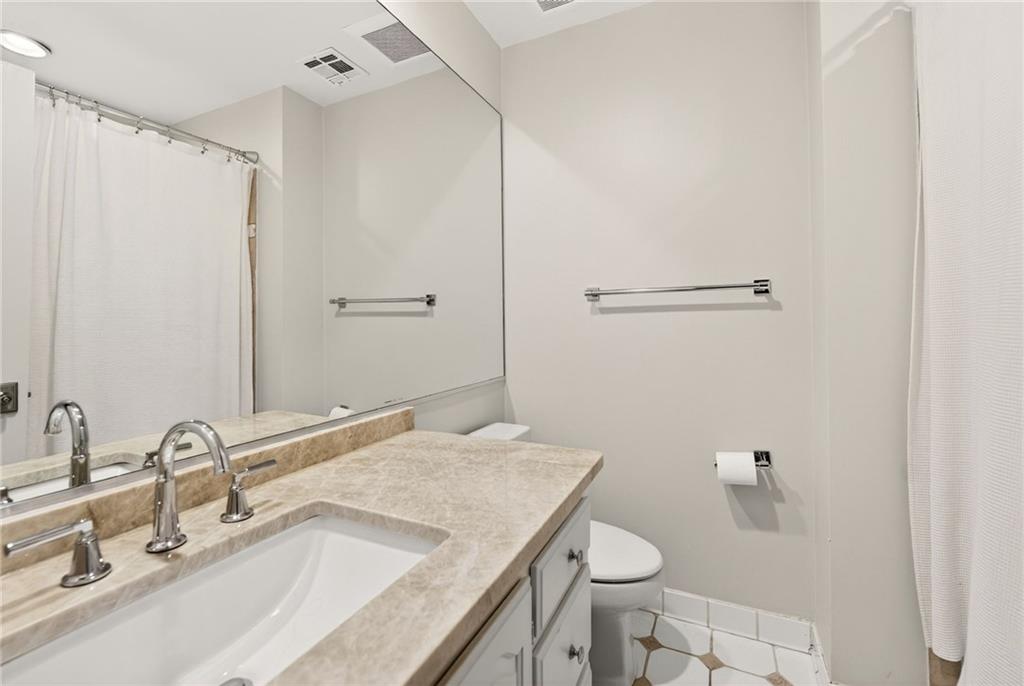 3650 Dumbarton Road Northwest Atlanta, GA 30327 - Photo 32 of 57 a bathroom with a granite countertop sink toilet and shower
