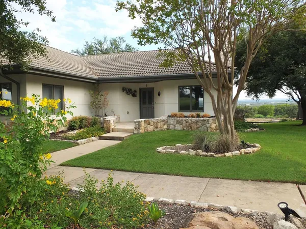 a front view of a house with garden