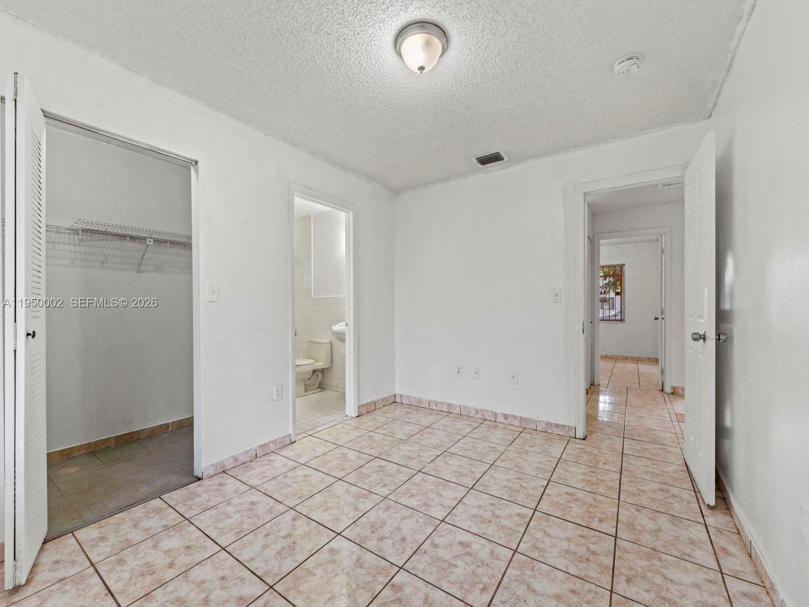 11075 Southwest 221st Terrace Miami, FL 33170 - Photo 11 of 31 a view of an empty room and window