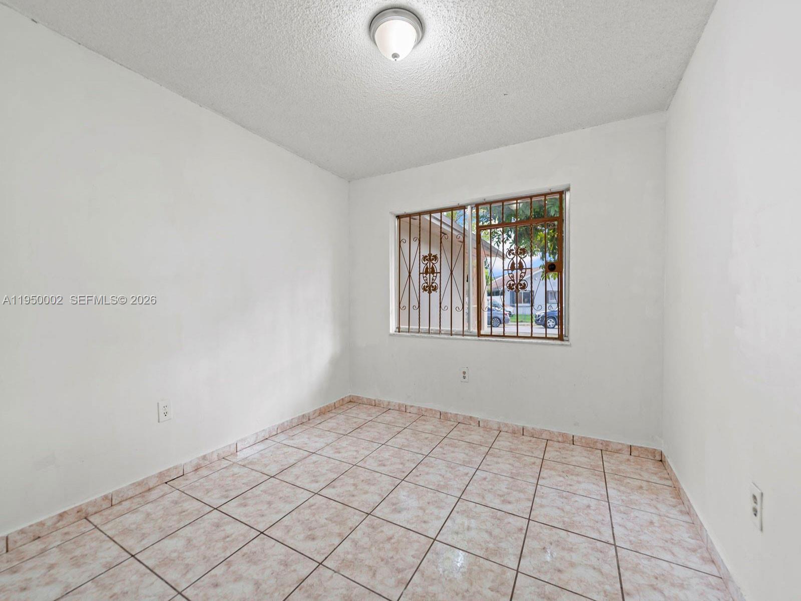 11075 Southwest 221st Terrace Miami, FL 33170 - Photo 12 of 31 a view of an empty room and window