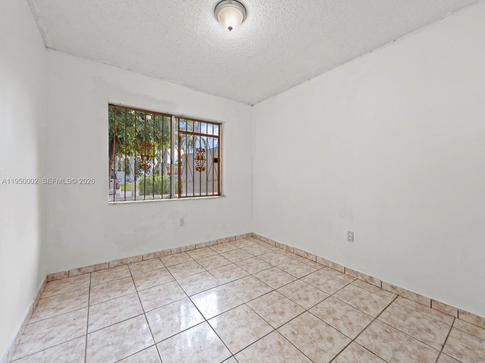 11075 Southwest 221st Terrace Miami, FL 33170 - Photo 16 of 31 an empty room with windows