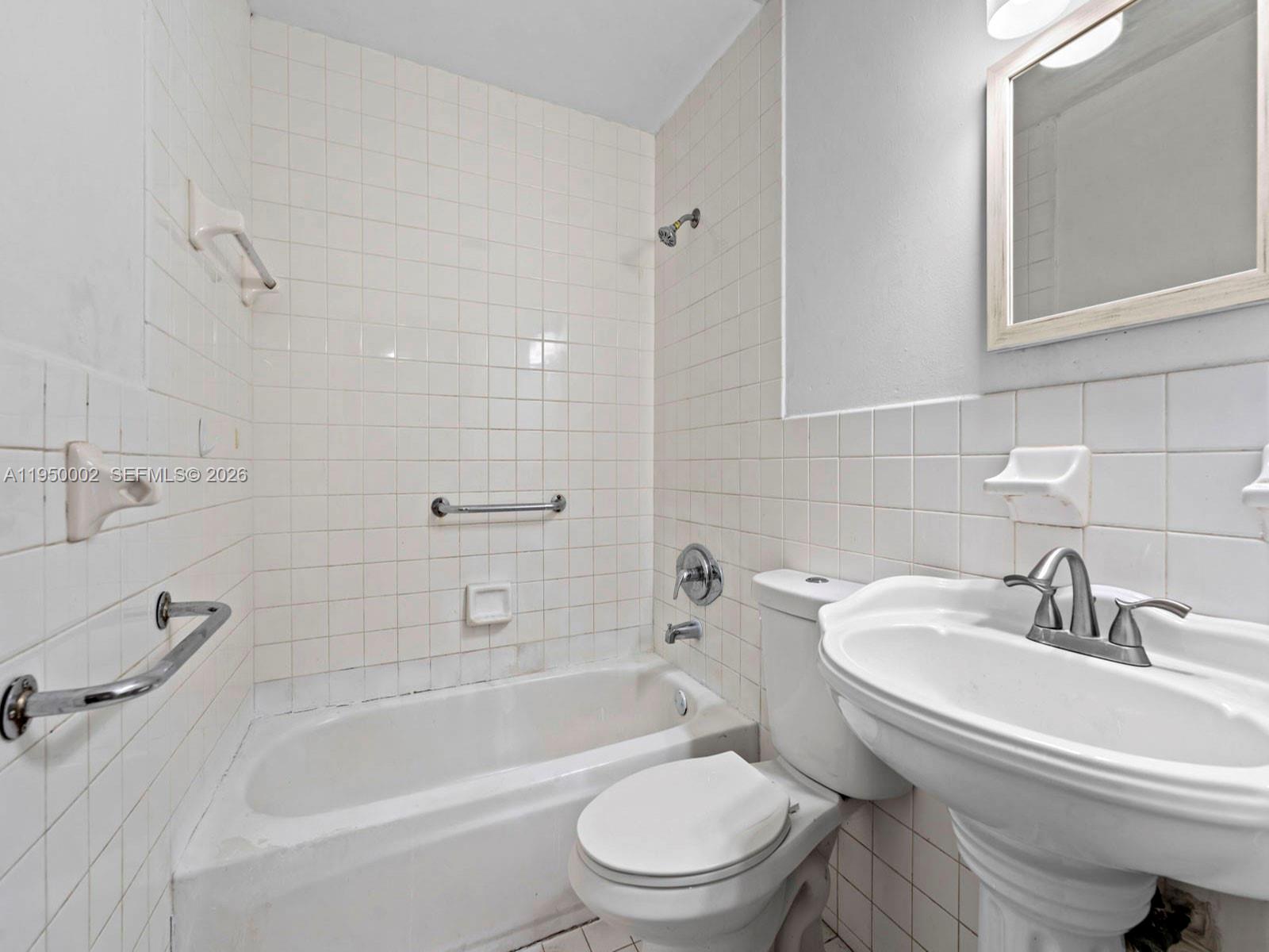 11075 Southwest 221st Terrace Miami, FL 33170 - Photo 18 of 31 a white toilet sitting next to a bath tub