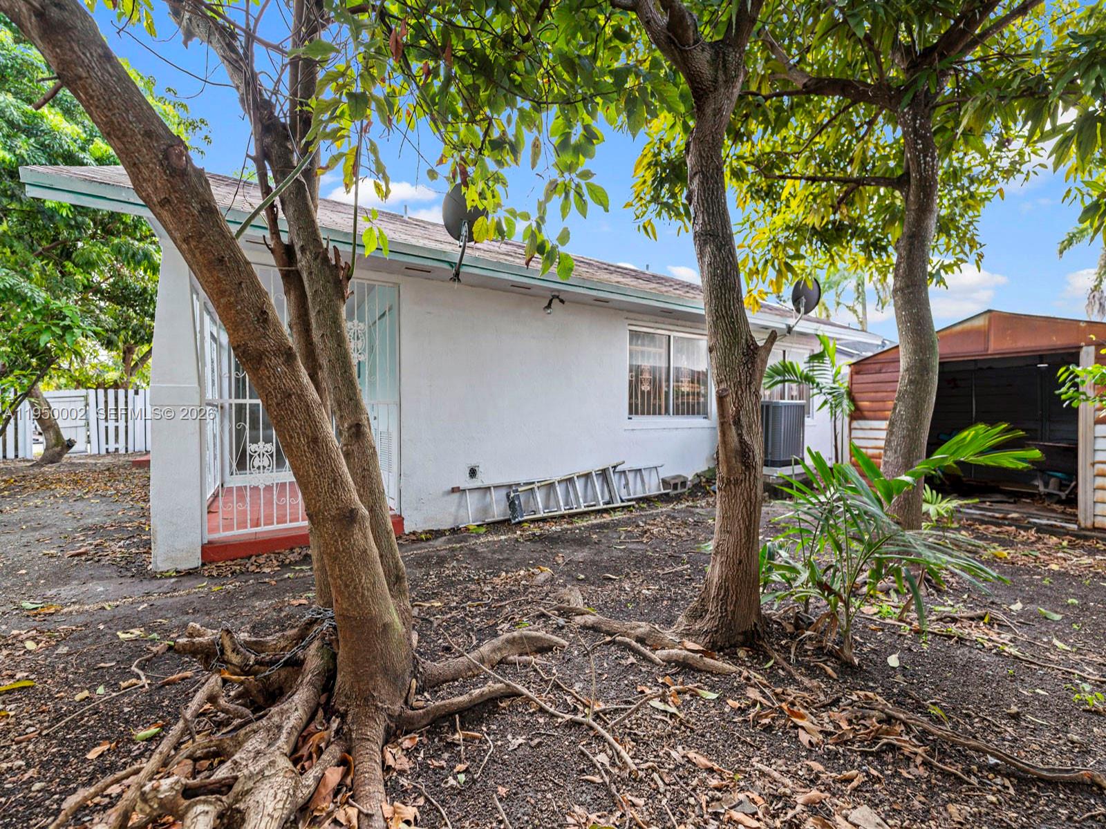 11075 Southwest 221st Terrace Miami, FL 33170 - Photo 23 of 31 a front view of a house with garden