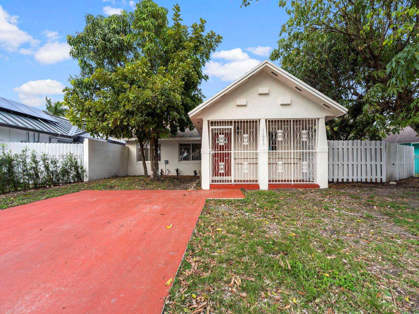 11075 Southwest 221st Terrace Miami, FL 33170 - Photo 24 of 31 a view of a house with backyard and tree