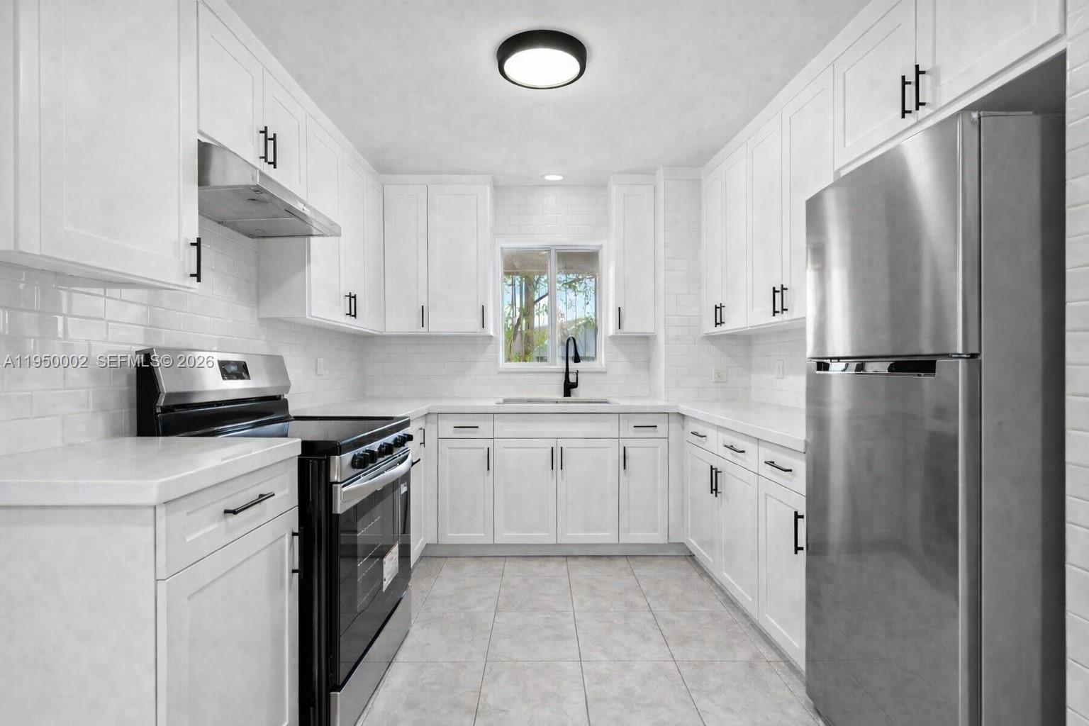 11075 Southwest 221st Terrace Miami, FL 33170 - Photo 26 of 31 a kitchen with stainless steel appliances a refrigerator sink and stove