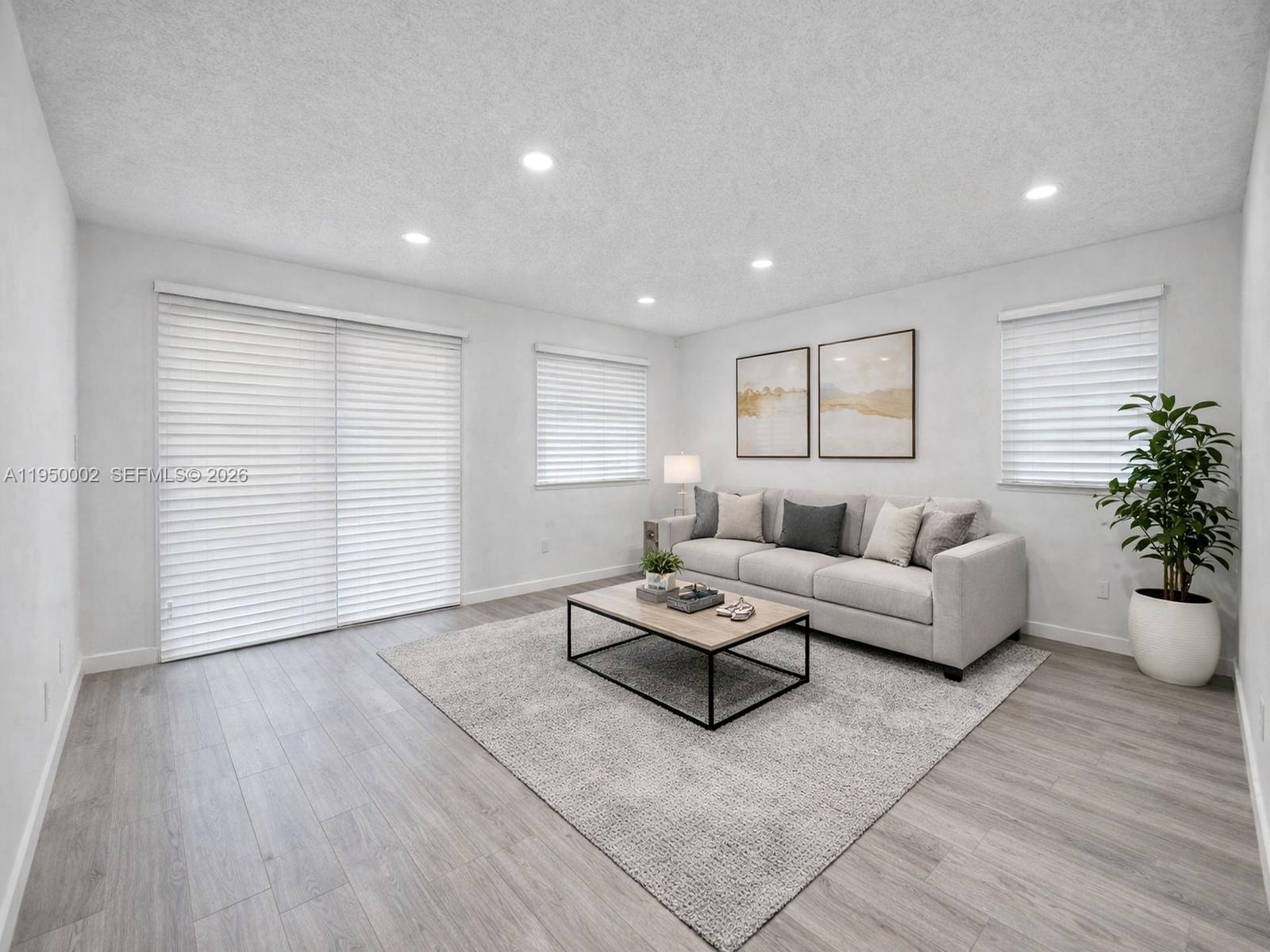 11075 Southwest 221st Terrace Miami, FL 33170 - Photo 27 of 31 a living room with furniture and flowers