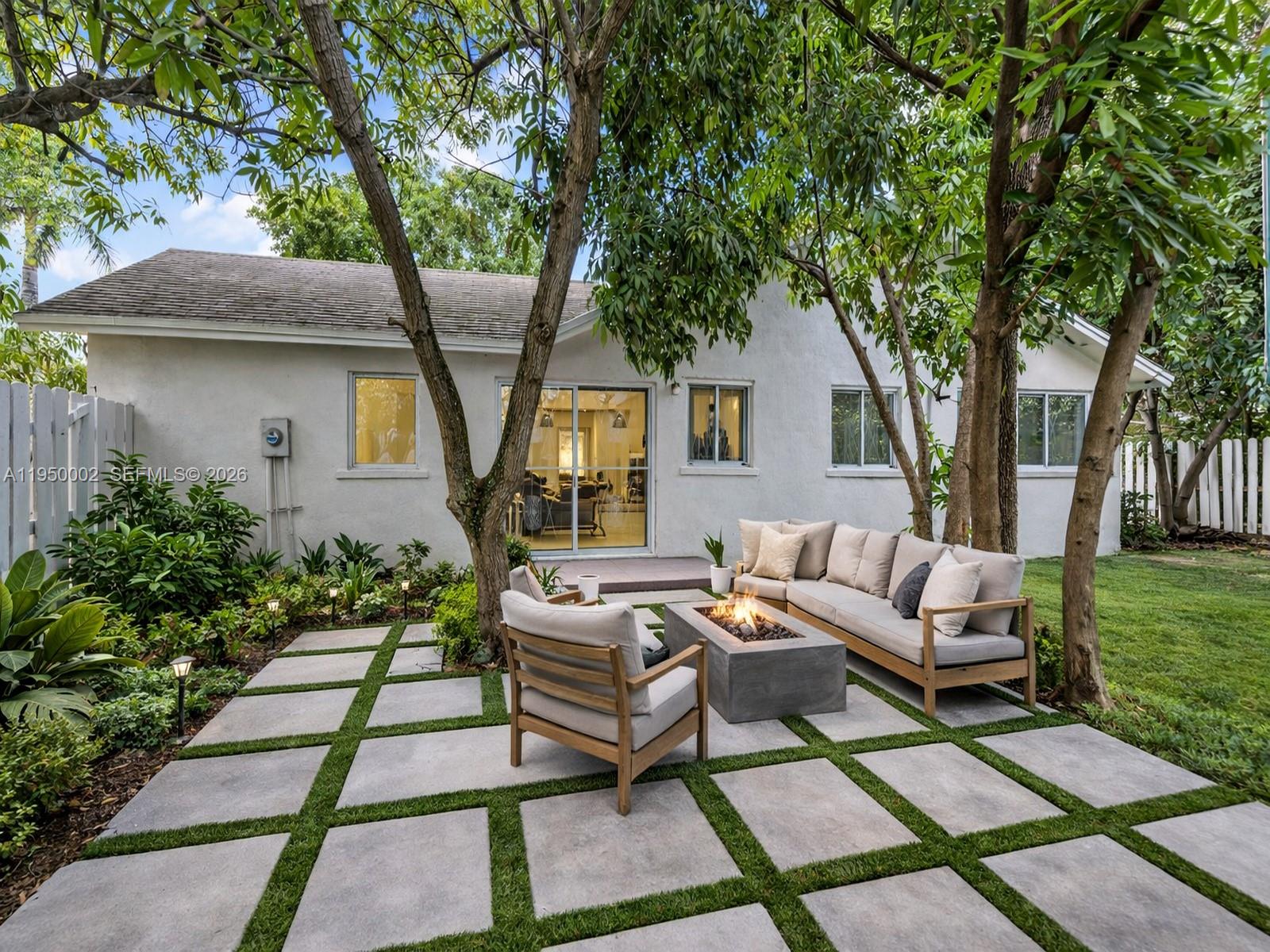 11075 Southwest 221st Terrace Miami, FL 33170 - Photo 31 of 31 a view of a patio with couches table and chairs with wooden fence and floor