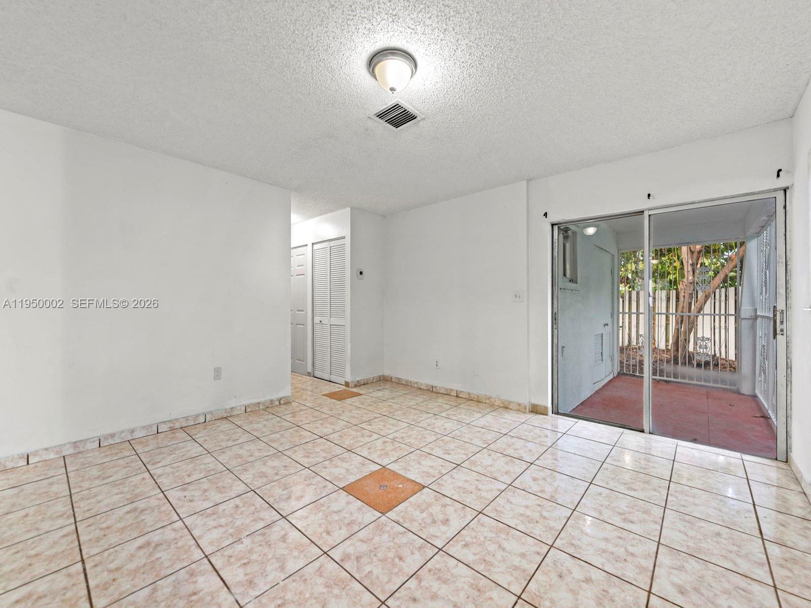 11075 Southwest 221st Terrace Miami, FL 33170 - Photo 5 of 31 a view of an empty room and window