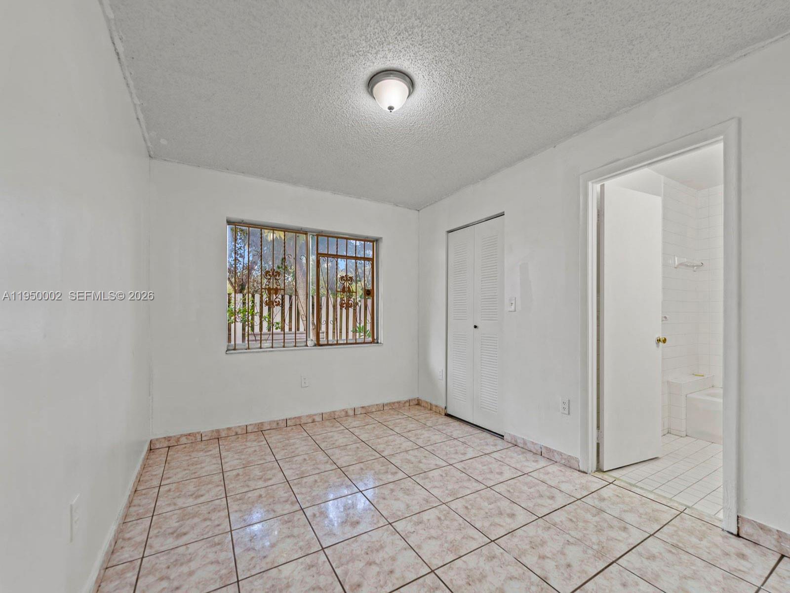 11075 Southwest 221st Terrace Miami, FL 33170 - Photo 9 of 31 a view of an empty room and window
