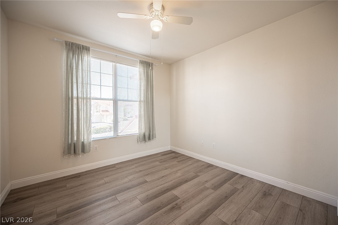 8555 West Russell Road, Unit 2062 Las Vegas, NV 89113 - Photo 28 of 35 A quiet bedroom with a large window and durable wood-look flooring awaits personalization.