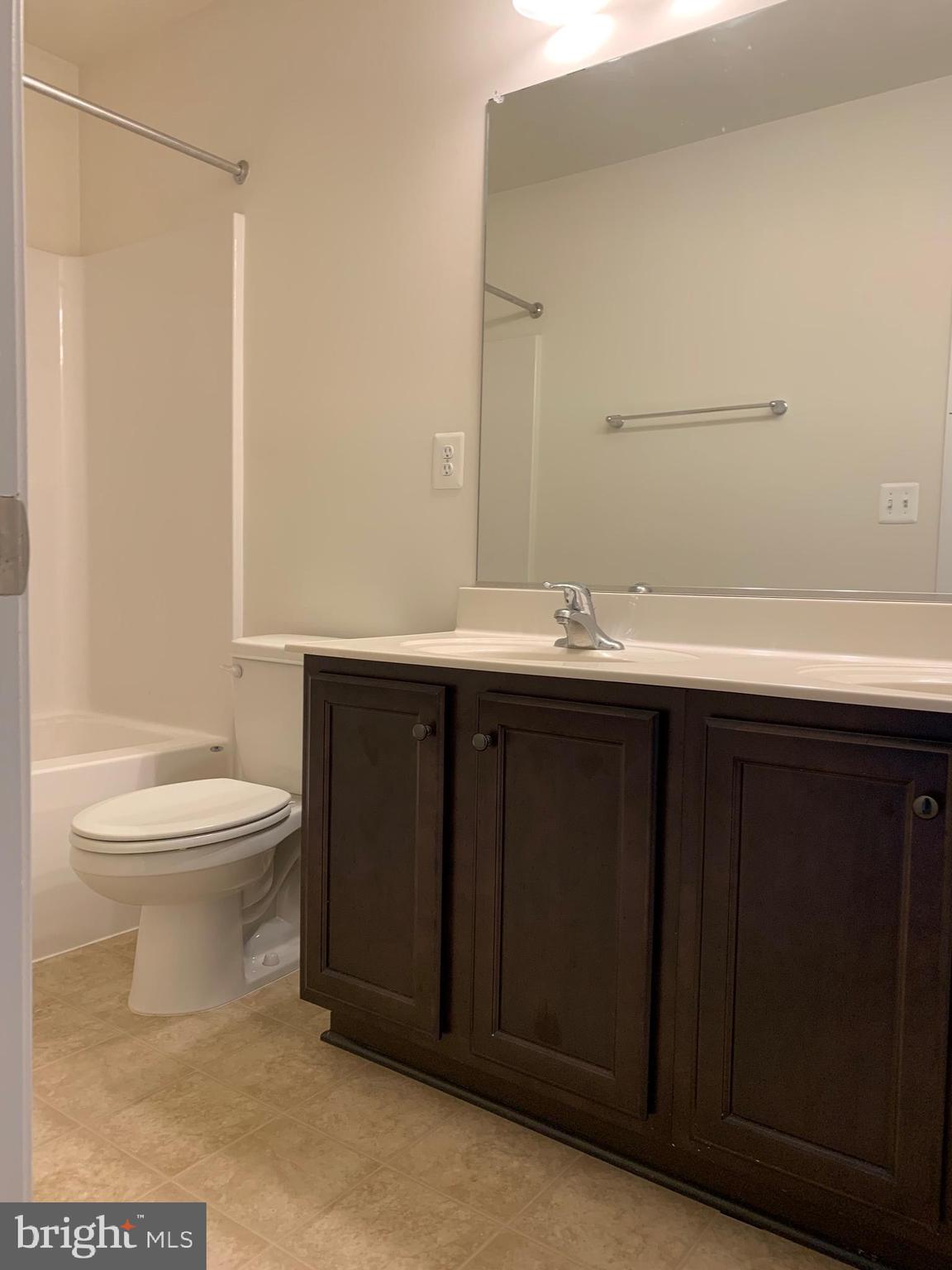 10421 Westgate Court Ruther Glen, VA 22546 - Photo 11 of 13 a bathroom with a sink a toilet and shower