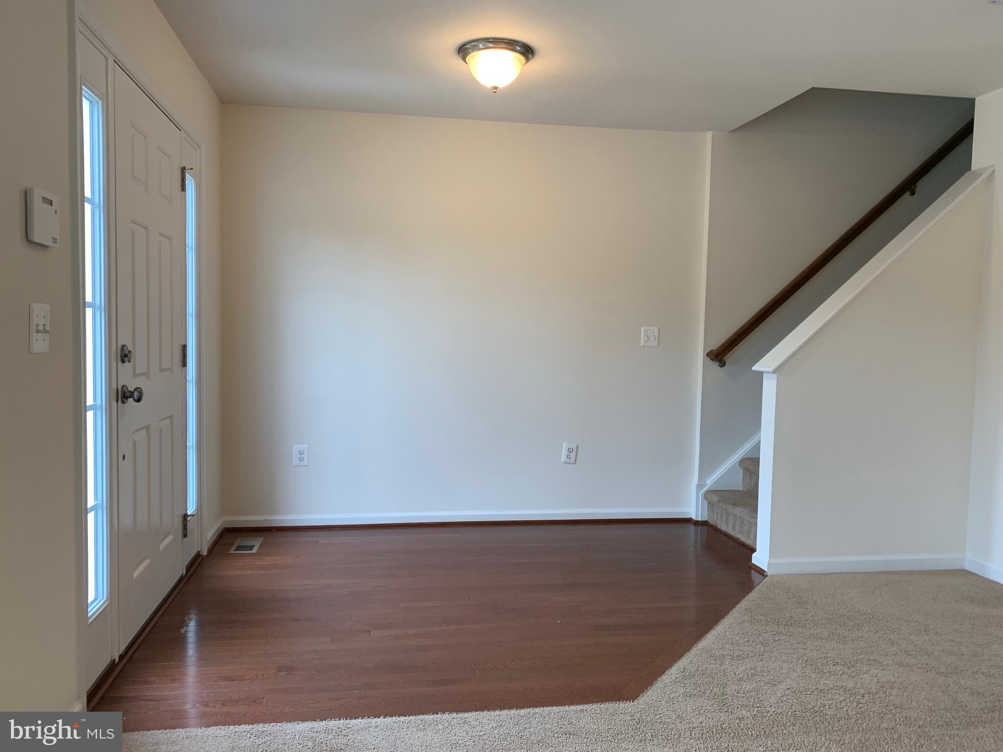 10421 Westgate Court Ruther Glen, VA 22546 - Photo 3 of 13 an empty room with wooden floor and windows