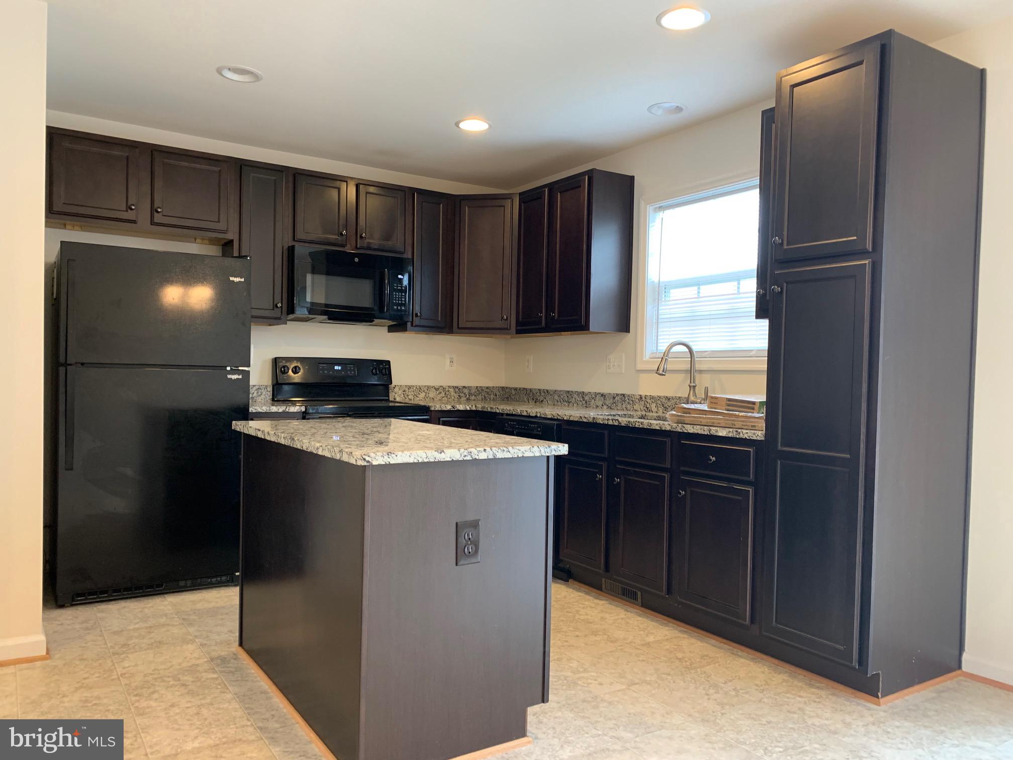 10421 Westgate Court Ruther Glen, VA 22546 - Photo 5 of 13 a kitchen with a refrigerator and a sink