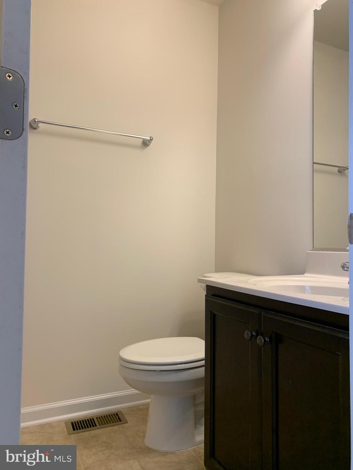 10421 Westgate Court Ruther Glen, VA 22546 - Photo 10 of 13 a bathroom with a sink a toilet and a mirror