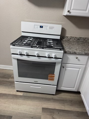 153 Union Street, Unit 1B Lawrence, MA 01841 - Photo 4 of 10 a stove top oven sitting inside of a kitchen