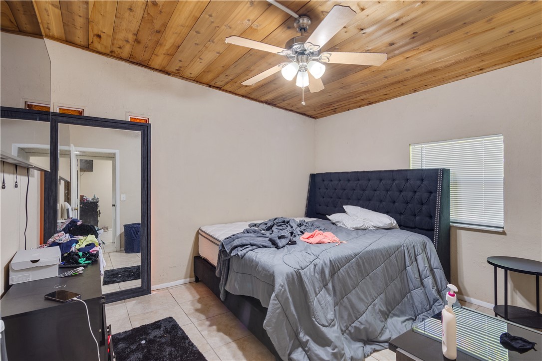 422 Del Monte Road Sebastian, FL 32958 - Photo 17 of 35 a bedroom with a bed and a chandelier