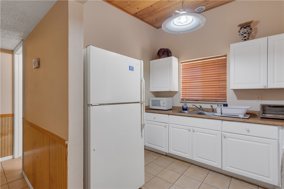 422 Del Monte Road Sebastian, FL 32958 - Photo 27 of 35 a kitchen with appliances a sink and cabinets