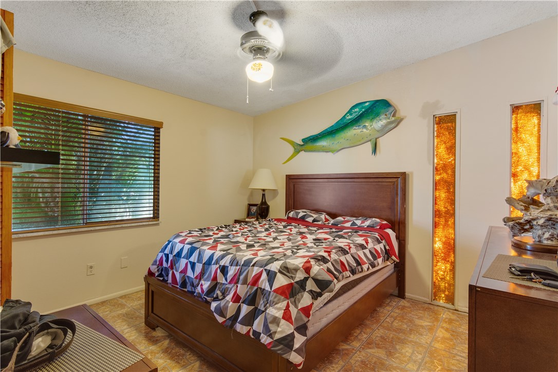 422 Del Monte Road Sebastian, FL 32958 - Photo 29 of 35 a bedroom with a bed dresser and a window