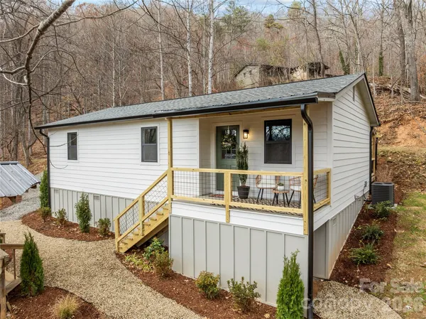 a view of a house with a yard and potted plants